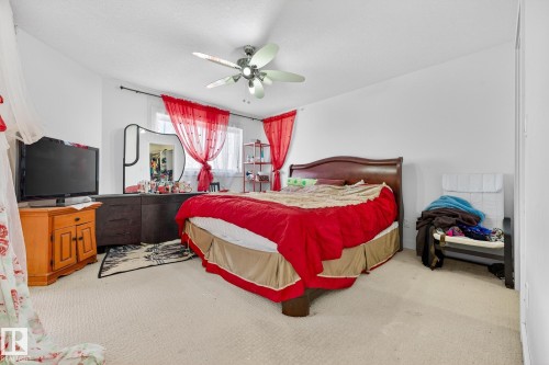 Bedroom with light carpet and ceiling fan - 1660 Malone Way, Edmonton, AB - Indoor Photo Showing Bedroom