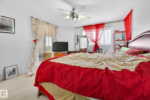 Bedroom featuring carpet flooring, ceiling fan, and multiple windows - 1660 Malone Way, Edmonton, AB - Indoor Photo Showing Bedroom
