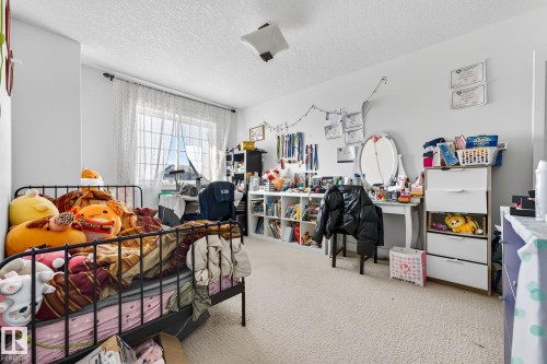 Bedroom with light carpet and a textured ceiling - 1660 Malone Way, Edmonton, AB - Indoor