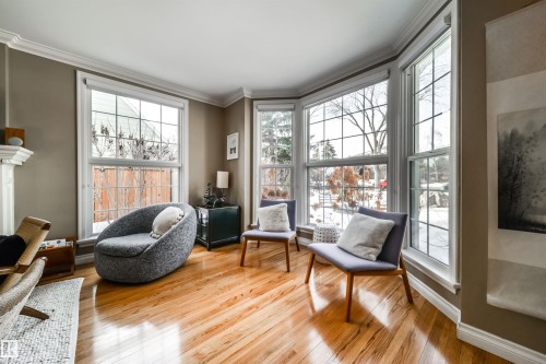 Living area featuring light wood-style flooring and crown molding - 10445 134 Street, Edmonton, AB - Indoor Photo Showing Other Room