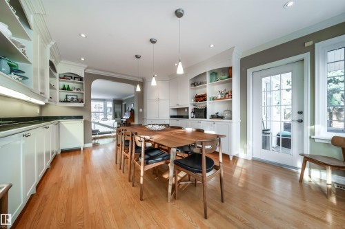 Dining area featuring arched walkways, light wood finished floors, ornamental molding, and recessed lighting - 10445 134 Street, Edmonton, AB - Indoor