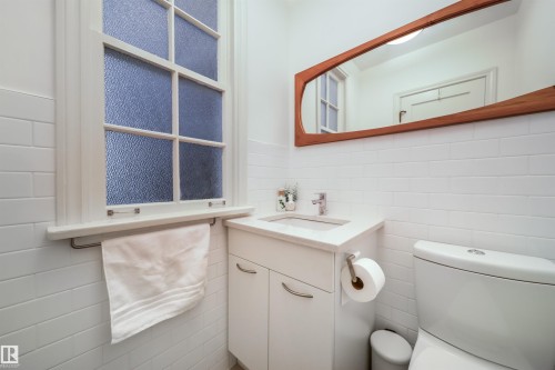 Half bath with vanity and tile walls - 10445 134 Street, Edmonton, AB - Indoor Photo Showing Bathroom