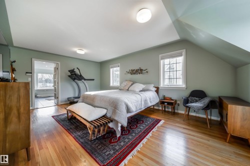 Bedroom with light wood-style floors and vaulted ceiling - 10445 134 Street, Edmonton, AB - Indoor Photo Showing Bedroom