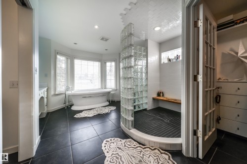 Bathroom with a freestanding bath, a walk in shower, vanity, dark tile patterned floors, and recessed lighting - 10445 134 Street, Edmonton, AB - Indoor