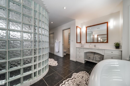 Bathroom featuring vanity, dark tile patterned flooring, and recessed lighting - 10445 134 Street, Edmonton, AB - Indoor