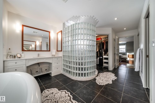 Full bathroom featuring vanity, a walk in closet, dark tile patterned floors, a bathtub, and recessed lighting - 10445 134 Street, Edmonton, AB - Indoor Photo Showing Bathroom