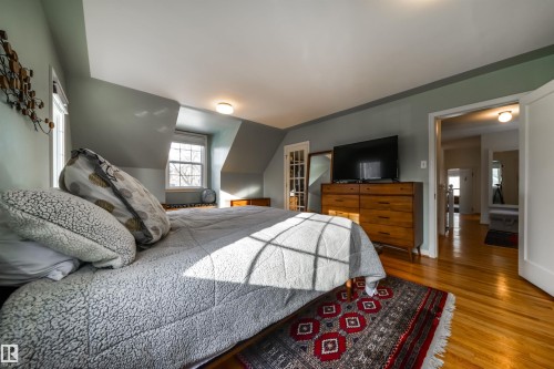 Bedroom with wood finished floors, access to outside, and vaulted ceiling - 10445 134 Street, Edmonton, AB - Indoor Photo Showing Bedroom