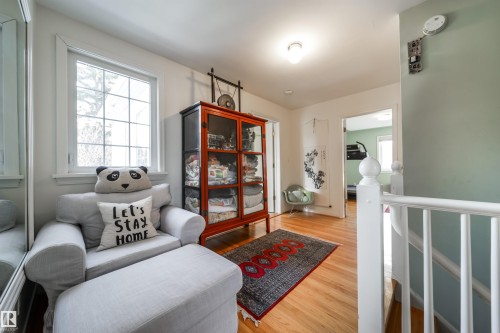 Living area with light wood finished floors and an upstairs landing - 10445 134 Street, Edmonton, AB - Indoor