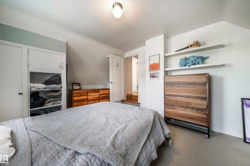 Bedroom with dark colored carpet and a closet - 10445 134 Street, Edmonton, AB - Indoor Photo Showing Bedroom