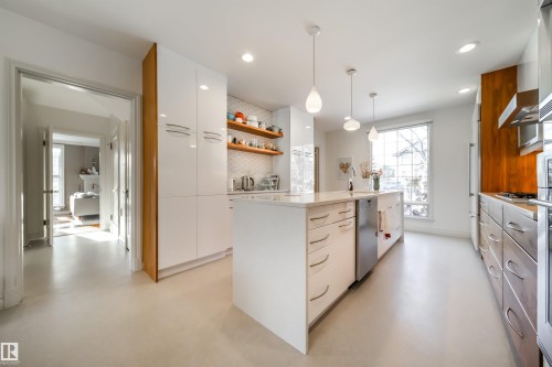 Kitchen with modern cabinets, a kitchen island, open shelves, light stone counters, and ventilation hood - 10445 134 Street, Edmonton, AB - Indoor Photo Showing Kitchen With Upgraded Kitchen