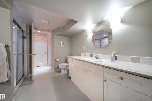 Full bathroom with a shower stall, vanity, and concrete floors - 10445 134 Street, Edmonton, AB - Indoor Photo Showing Bathroom