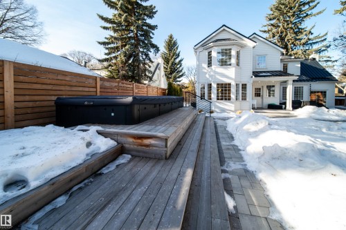 Snow covered rear of property with a deck and a metal roof - 10445 134 Street, Edmonton, AB - Outdoor With Deck Patio Veranda