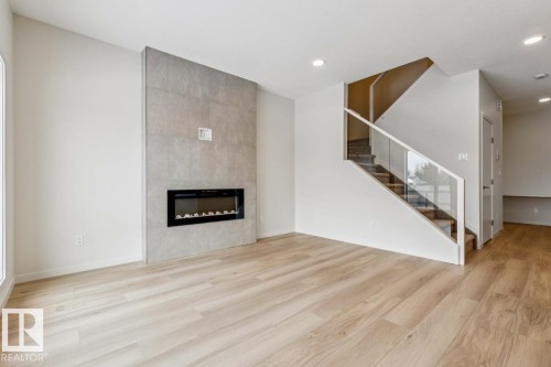 25 Stetson Loop, Ardrossan, AB - Indoor Photo Showing Living Room With Fireplace