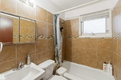 Bathroom featuring shower / bath combo with shower curtain and tile walls - 