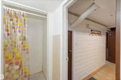 Bathroom with a shower stall and tile patterned floors - 