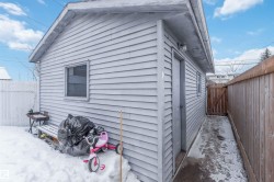View of side of property with a fenced backyard and a gate - 