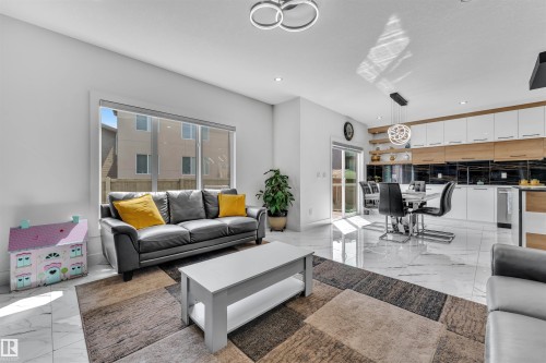 Living area featuring light marble finish floors and recessed lighting - 1809 18A Avenue, Edmonton, AB - Indoor Photo Showing Living Room