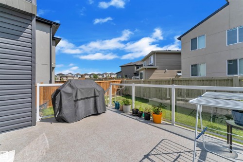 Fenced backyard with grilling area, a residential view, and a patio - 1809 18A Avenue, Edmonton, AB - Outdoor With Exterior