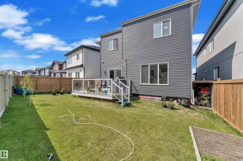 Back of house with a wooden deck, a fenced backyard, and a residential view - 1809 18A Avenue, Edmonton, AB - Outdoor With Exterior