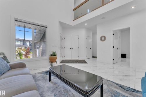 Living room with recessed lighting, light marble finish flooring, and a high ceiling - 1809 18A Avenue, Edmonton, AB - Indoor Photo Showing Living Room