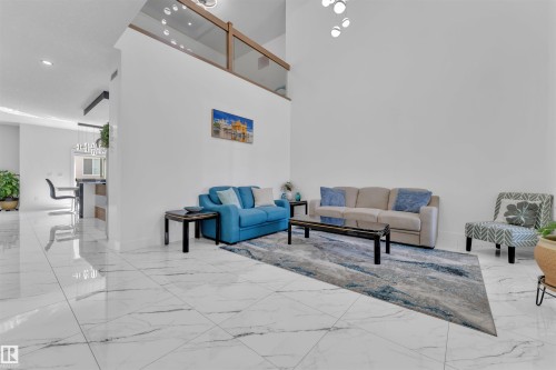 Living room featuring light marble finish flooring and a high ceiling - 1809 18A Avenue, Edmonton, AB - Indoor Photo Showing Other Room