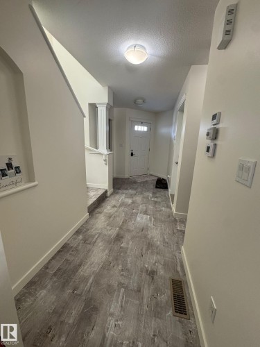 Hall featuring dark wood finished floors and a textured ceiling - 17703 65 Street, Edmonton, AB - Indoor Photo Showing Other Room