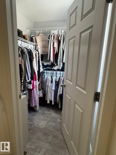 Walk in closet featuring dark wood-style flooring - 17703 65 Street, Edmonton, AB - Indoor With Storage