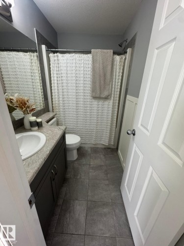 Bathroom with vanity and a textured ceiling - 17703 65 Street, Edmonton, AB - Indoor Photo Showing Bathroom