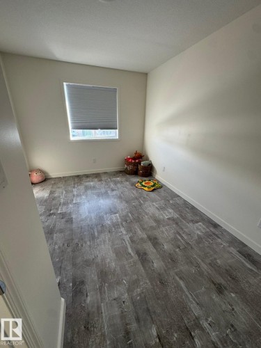 Spare room featuring dark wood finished floors and a textured ceiling - 17703 65 Street, Edmonton, AB - Indoor Photo Showing Other Room