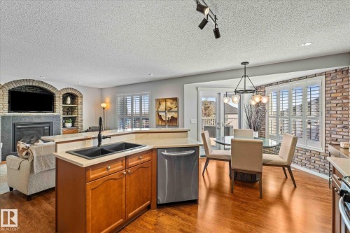 68 Greystone Crescent, Spruce Grove, AB - Indoor Photo Showing Kitchen With Fireplace With Double Sink