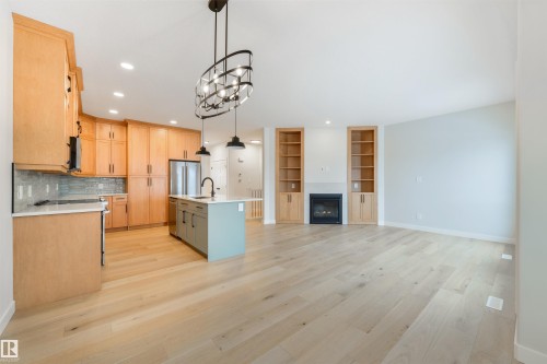 #23 1005 Calahoo Rd, Spruce Grove, AB - Indoor Photo Showing Kitchen With Fireplace