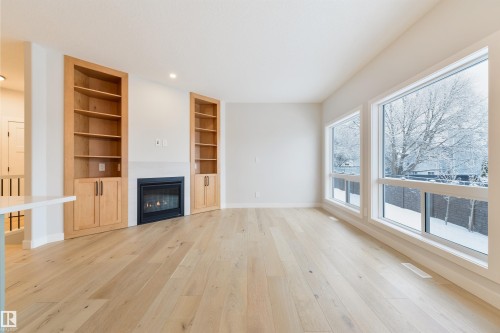 #23 1005 Calahoo Rd, Spruce Grove, AB - Indoor Photo Showing Other Room With Fireplace