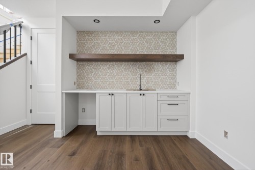 Indoor wet bar featuring white cabinets, backsplash, and open shelves - 149 Eastgate Way, St. Albert, AB - Indoor Photo Showing Other Room