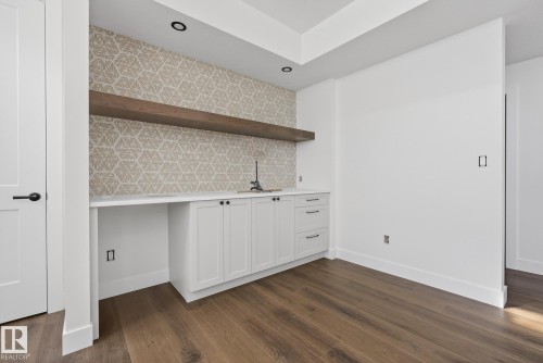 Indoor wet bar featuring white cabinetry, open shelves, dark wood finished floors, recessed lighting, and tasteful backsplash - 149 Eastgate Way, St. Albert, AB - Indoor Photo Showing Other Room