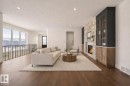 Living area with dark wood-style flooring, a textured ceiling, and a fireplace - 149 Eastgate Way, St. Albert, AB  - Indoor Photo Showing Living Room With Fireplace 