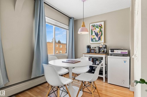 Dining room featuring light wood-type flooring and a baseboard radiator - 304 11420 40 Avenue Nw, Edmonton, AB - Indoor Photo Showing Dining Room