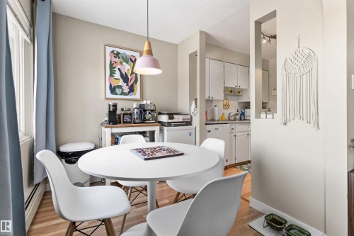 Dining area featuring light wood-style floors and baseboard heating - 304 11420 40 Avenue Nw, Edmonton, AB - Indoor Photo Showing Dining Room