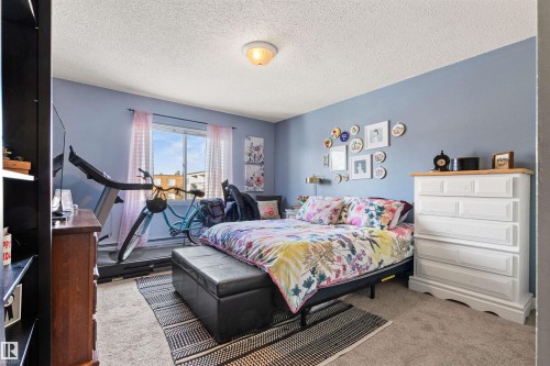 Carpeted bedroom with a textured ceiling - 304 11420 40 Avenue Nw, Edmonton, AB - Indoor Photo Showing Bedroom