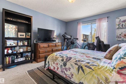 Bedroom featuring light carpet and a textured ceiling - 304 11420 40 Avenue Nw, Edmonton, AB - Indoor Photo Showing Bedroom