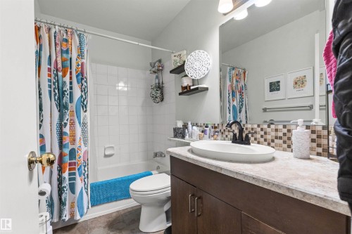 Full bathroom featuring vanity, decorative backsplash, and shower / bath combination with curtain - 304 11420 40 Avenue Nw, Edmonton, AB - Indoor Photo Showing Bathroom