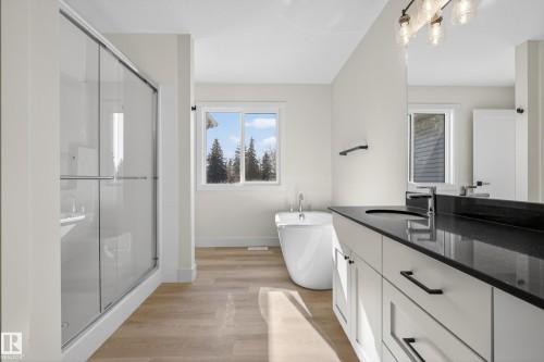Bathroom with vanity, light wood-style flooring, a stall shower, and a soaking tub - 22 Grayson Green, Stony Plain, AB - Indoor Photo Showing Bathroom
