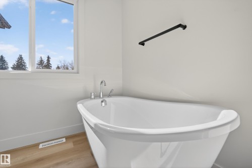 Bathroom with light wood-type flooring and a soaking tub - 22 Grayson Green, Stony Plain, AB - Indoor Photo Showing Bathroom