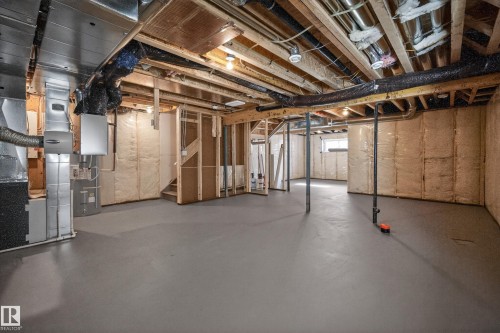 Below grade area with stairs and heating unit - 22 Grayson Green, Stony Plain, AB - Indoor Photo Showing Basement