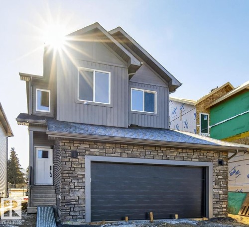 View of front of house with stone siding, board and batten siding, and a garage - 22 Grayson Green, Stony Plain, AB - Outdoor
