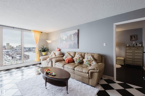 Living area with a textured ceiling and light flooring - 1803 10149 Saskatchewan Drive, Edmonton, AB - Indoor Photo Showing Living Room