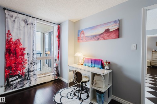 Home office featuring a textured ceiling and dark wood-style flooring - 1803 10149 Saskatchewan Drive, Edmonton, AB - Indoor