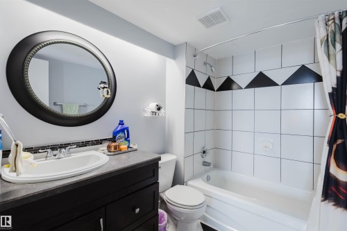 Bathroom featuring vanity and shower / bath combo - 1803 10149 Saskatchewan Drive, Edmonton, AB - Indoor Photo Showing Bathroom