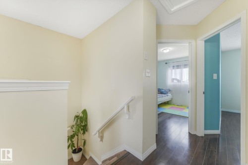 Corridor with dark wood-type flooring and an upstairs landing - 2348 28B Avenue, Edmonton, AB - Indoor Photo Showing Other Room