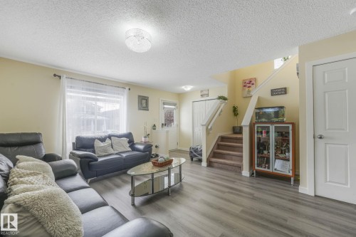 Living area with a textured ceiling and wood finished floors - 2348 28B Avenue, Edmonton, AB - Indoor Photo Showing Living Room