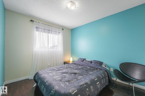 Bedroom featuring dark wood finished floors. Bright big windows giving lots of natural light. - 2348 28B Avenue, Edmonton, AB - Indoor Photo Showing Bedroom